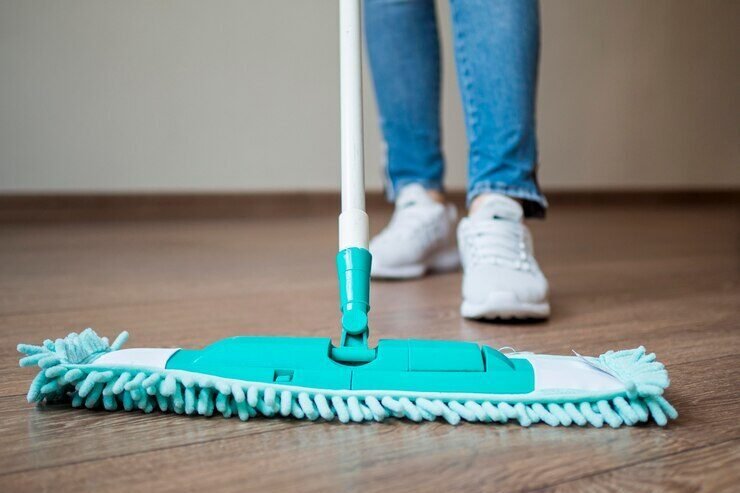 close-up-individual-mopping-floor_23-2148529586